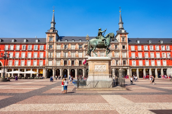 Le monument central de la Plaza Mayor Vue panoramique de la Plaza Mayor de Madrid et de ses arcades rouges